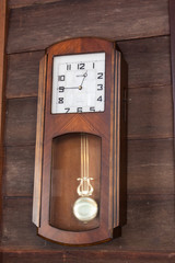 old wood clock hang on wood wall