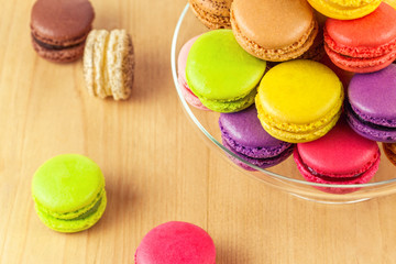 french colorful macarons in a glass cake stand