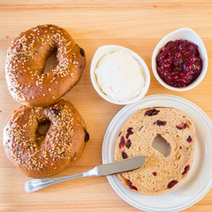 Homemade whole grain bagels with sesame seeds and cranberries.