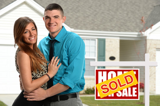 Young Couple In Front of New Home
