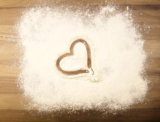 Flour on the table with heart