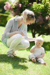 Fototapeta premium Happy mother with her little son outdoor