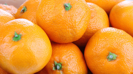 Ripe sweet tangerines in wooden box, isolated on white
