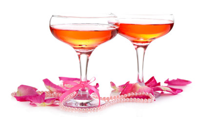 Composition with pink sparkle wine in glasses and  rose petals