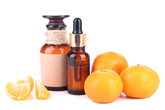 Tangerine essential oil and tangerines, isolated on white