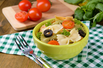 Delicious pasta with tomatoes on plate on table close-up
