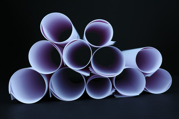 White paper rolls on black background close-up