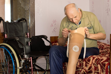 Fototapeta na wymiar Senior man checking the cup on his prosthetic leg