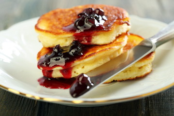 Pancakes with ricotta and cowberry sauce.