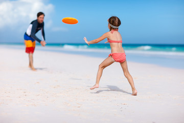 Father and daughter playing frisbee