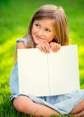 Adorable little girl reading book