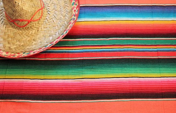 Mexican blanket cinco de mayo Mexico poncho sombrero poncho with sombrero background mexico fiesta copy space pattern stripes copy space serape blanket stock photo, stock photograph, image, picture, 