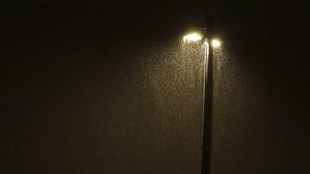 Lamppost in evening in heavy snowstorm