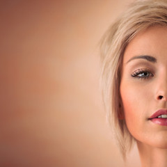 Elegant blonde beauty half face closeup portrait with copyspace