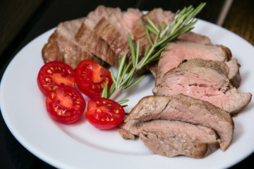 Juicy steak on the plate with tomatoes