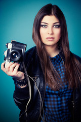 beautiful young woman holding camera