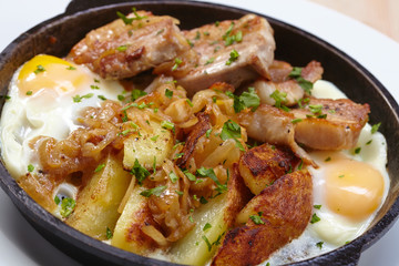 fried meat with potatoes and egg