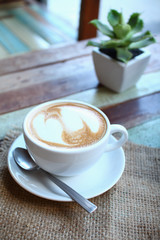 Hearts latte art coffee cup on grunge wood table