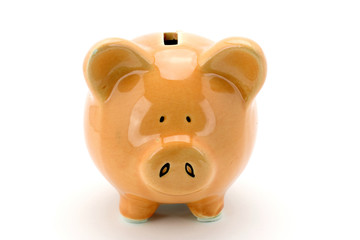 Pink piggy bank standing on a white background.