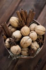 Walnuts and spices in a bowl, view from above