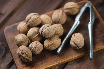 Walnuts over rustic wooden background