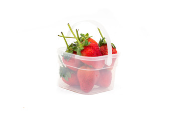 strawberries in plastic basket on white background