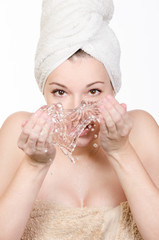 Young woman washing her face with water - 60981942