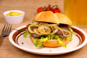 Ochsen semmel, grilled beef and onion rings in bun, beer