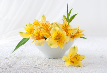 Bouquet of yellow flowers stands on a table