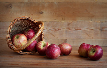 Apples in a basket on a wooden background