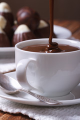 jet chocolate being poured into a cup closeup