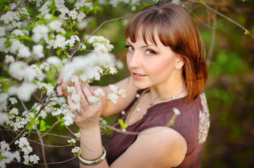 Beautiful young girl in a park on a spring day