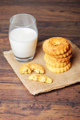 A glass of milk and cookies on a sack cloth