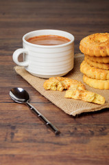 Breakfast cup with cookies on linen