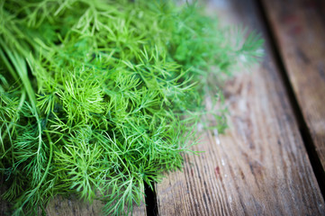 Fresh dill on rustic wooden table © ehaurylik