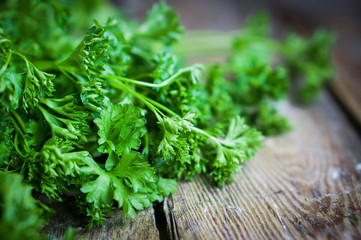 Fresh parsley on rustic wooden background