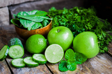 Green fruits and vegetables on wooden background