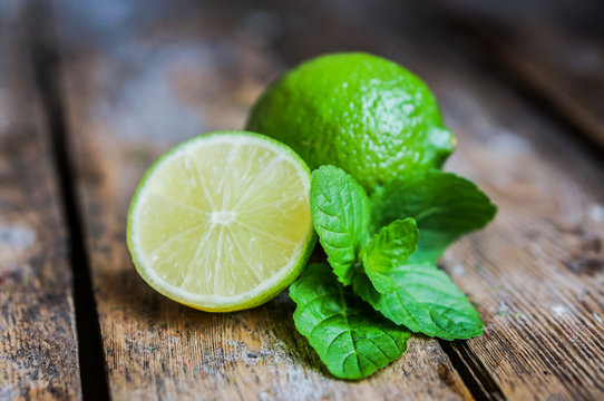 Lime and mint on wooden background