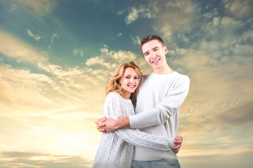 Couple embracing and holding one another under the sunny sky