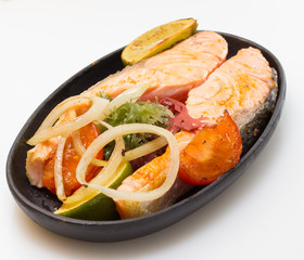 Raw salmon fillet with vegetables on white background