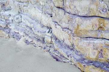 Obraz na płótnie Canvas The purple rock on the beach