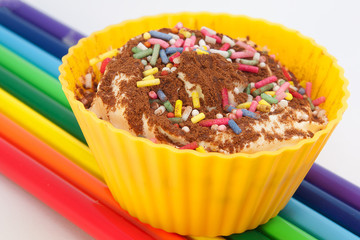 colorful cupcake with chocolate powder and sugar crops