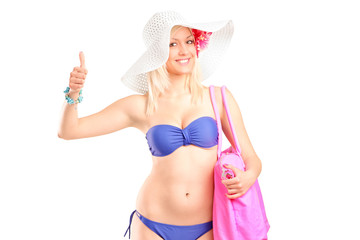 Attractive blond woman in bikini giving a thumb up