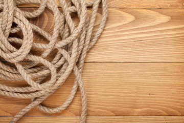 Ship rope on old wooden texture background
