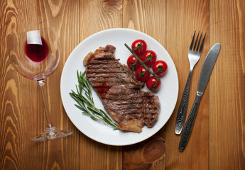 Sirloin steak with rosemary and cherry tomatoes on a plate