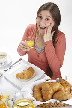 Junge Frau beim Frühstück - Orangensaft trinken