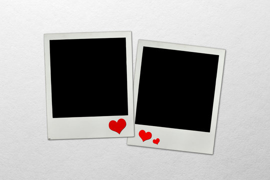 Photo frames on paper background with paper hearts
