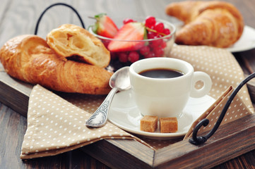 Cup of coffee with croissants