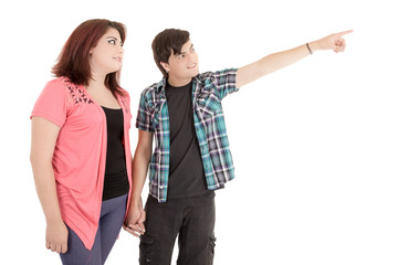alternative young couple pointing finger to empty copy space