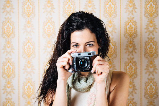 Woman taking photo with old camera